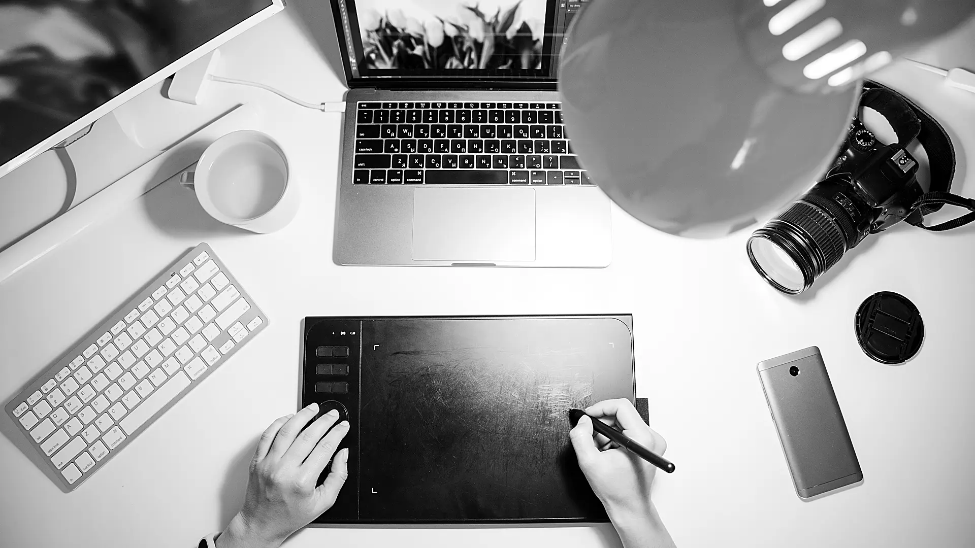 Camera lens and tablet on a desk